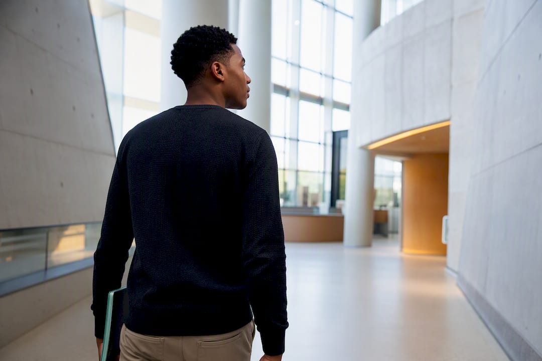 Student entering university admissions atrium