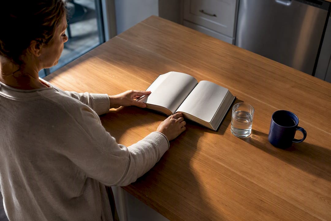 Caregiver preparing Bible beside morning water