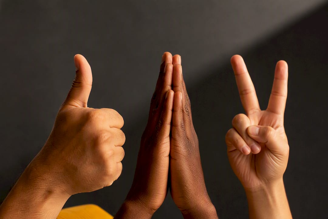 Diverse hands making recognizable emoji gestures