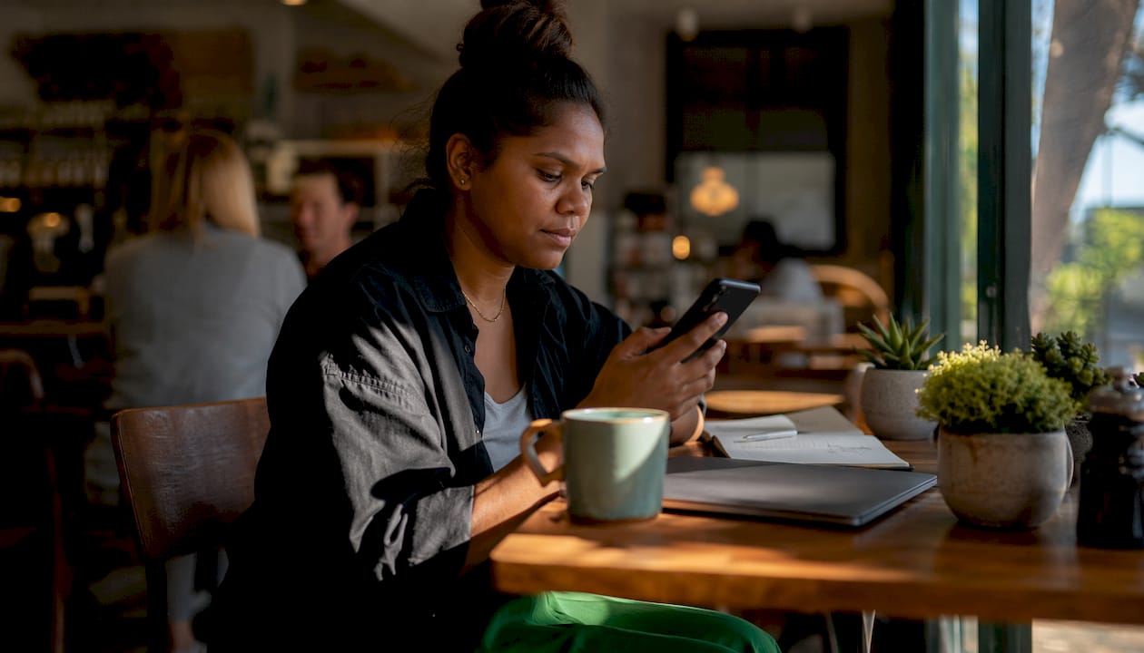 Woman booking skip bin online at home desk