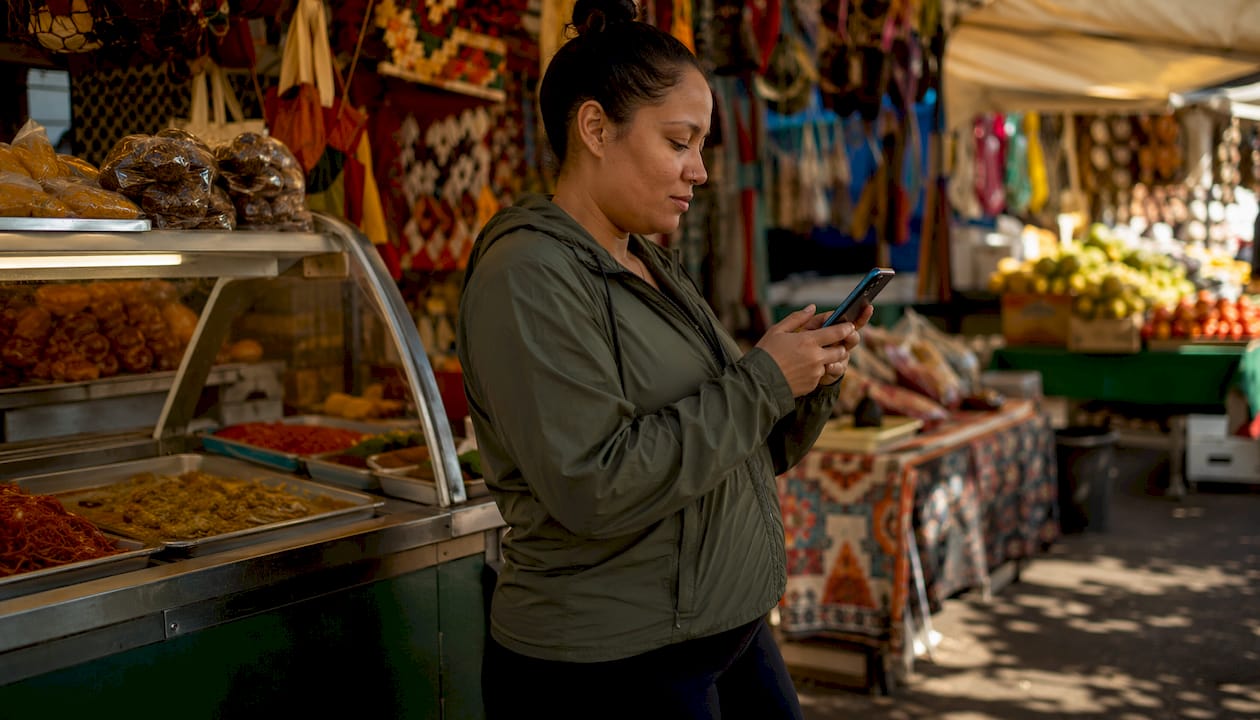Young woman booking skip bin hire on phone