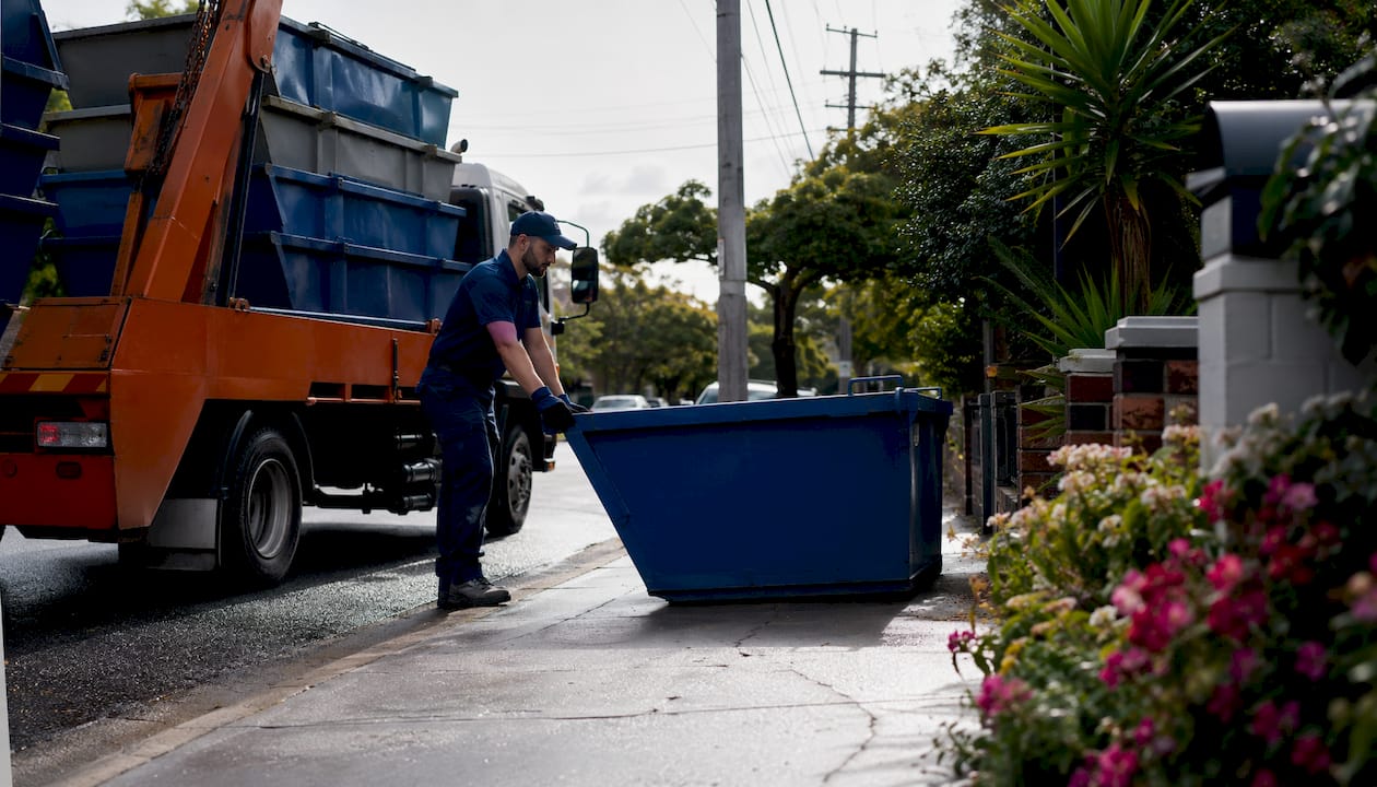 Delivery truck unloading skip bin locally