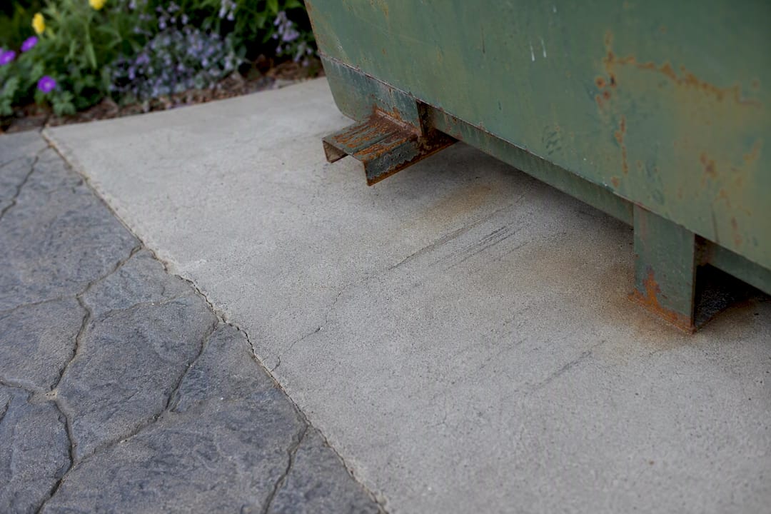 Close-up of driveway cracks, scuffs, and rust stains