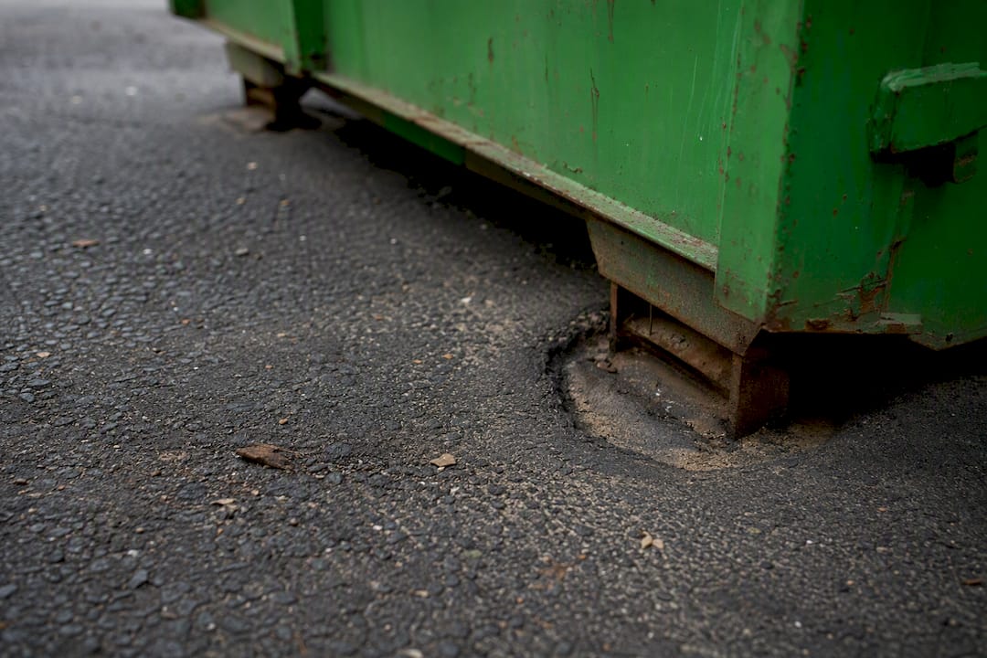 Indentation in hot asphalt under skip bin feet