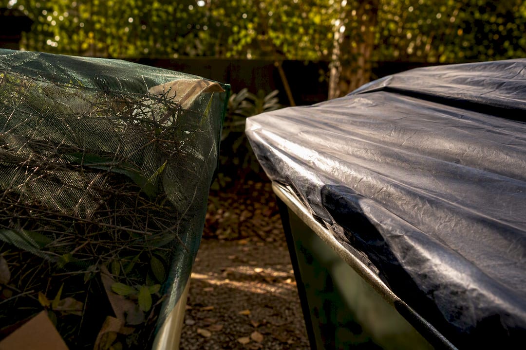 Skip bins with mesh and solid tarp covers