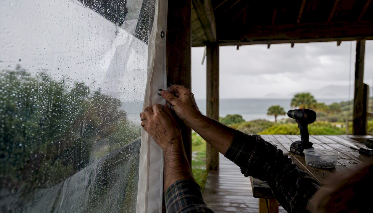 Hands installing waterproof marine-grade PVC blind