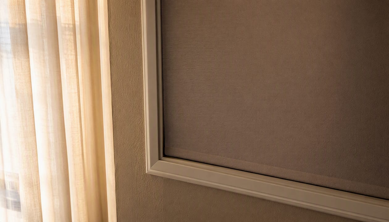 Roller shade overlapping window frame edges