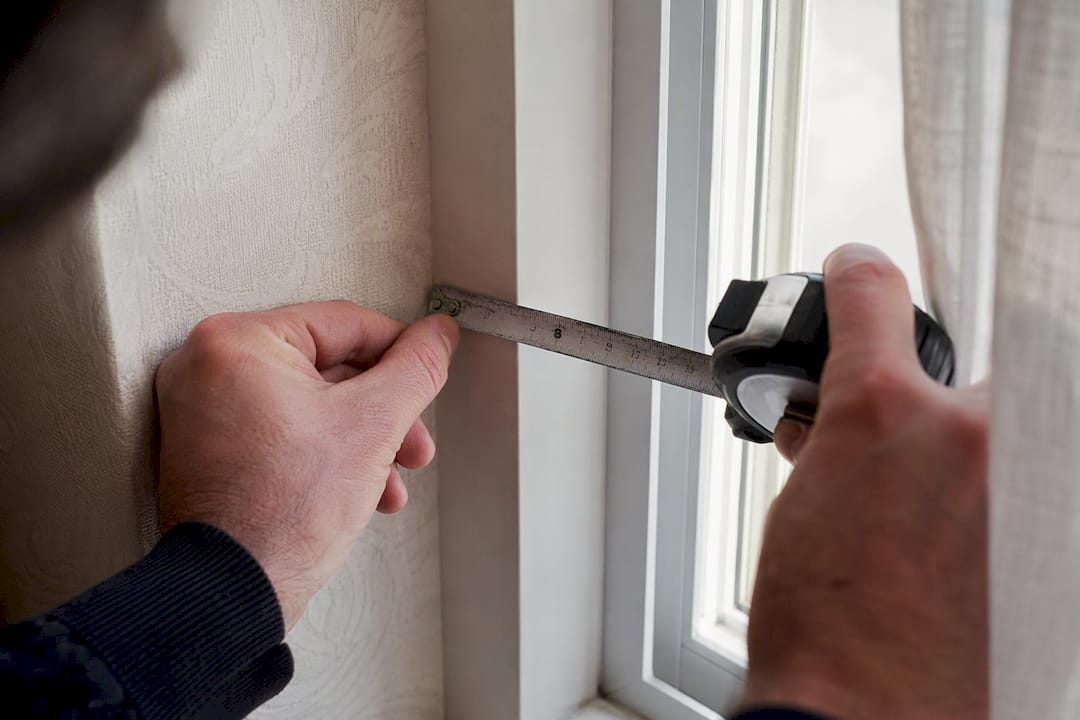 Hands measuring window recess reveal depth