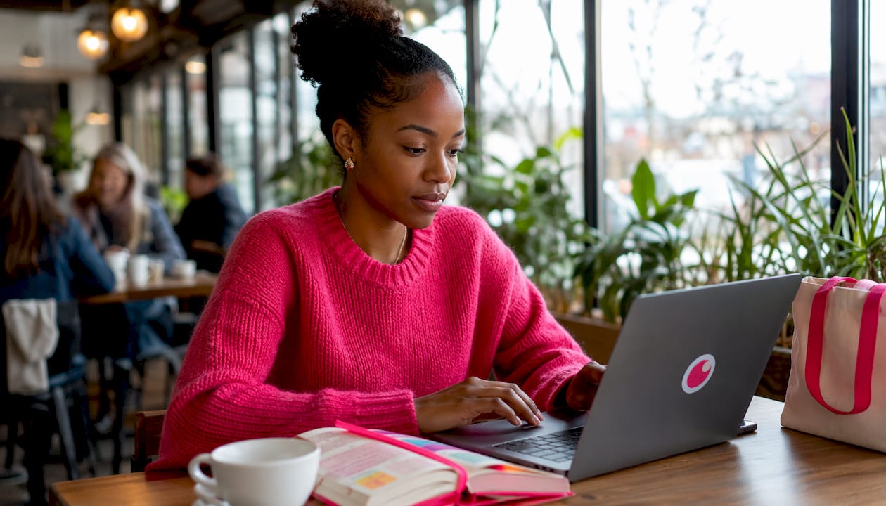 Woman using AI ad creative software on laptop