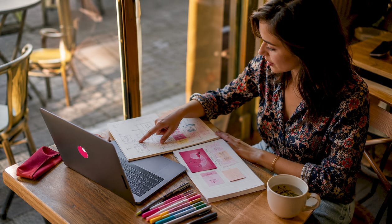 Marketer reviewing AI ad creative concepts at desk