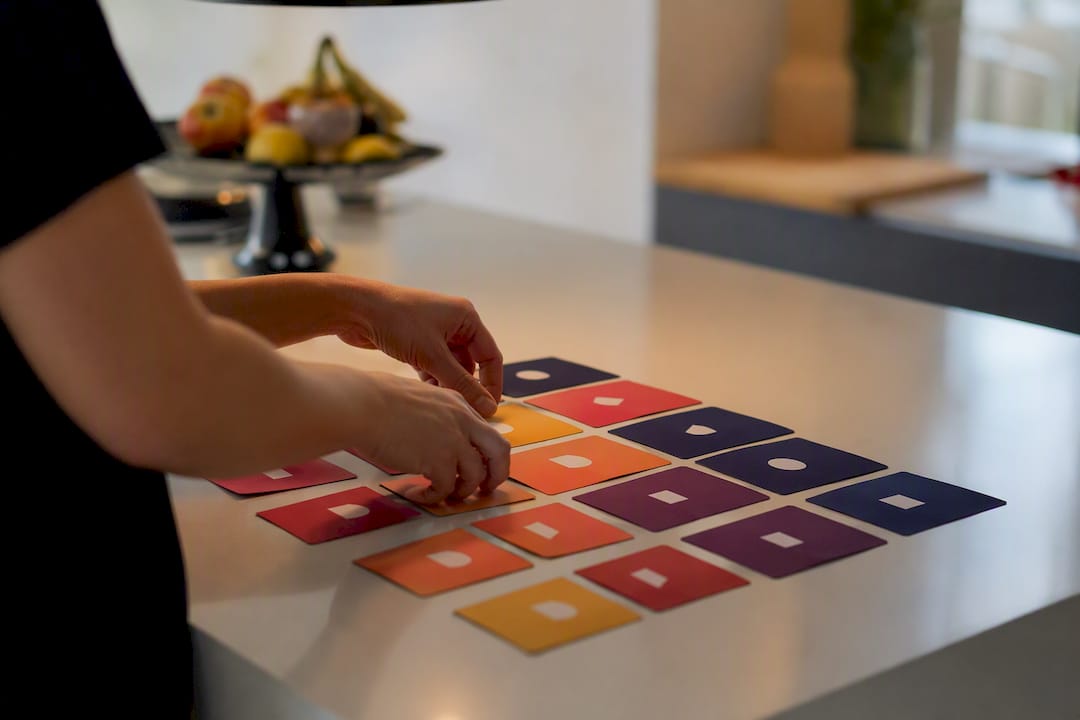 Hands organizing labeled creative asset cards