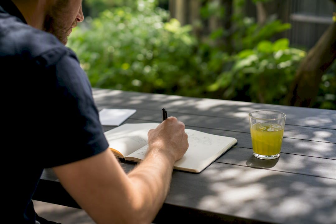 Hand writing test log in notebook on desk