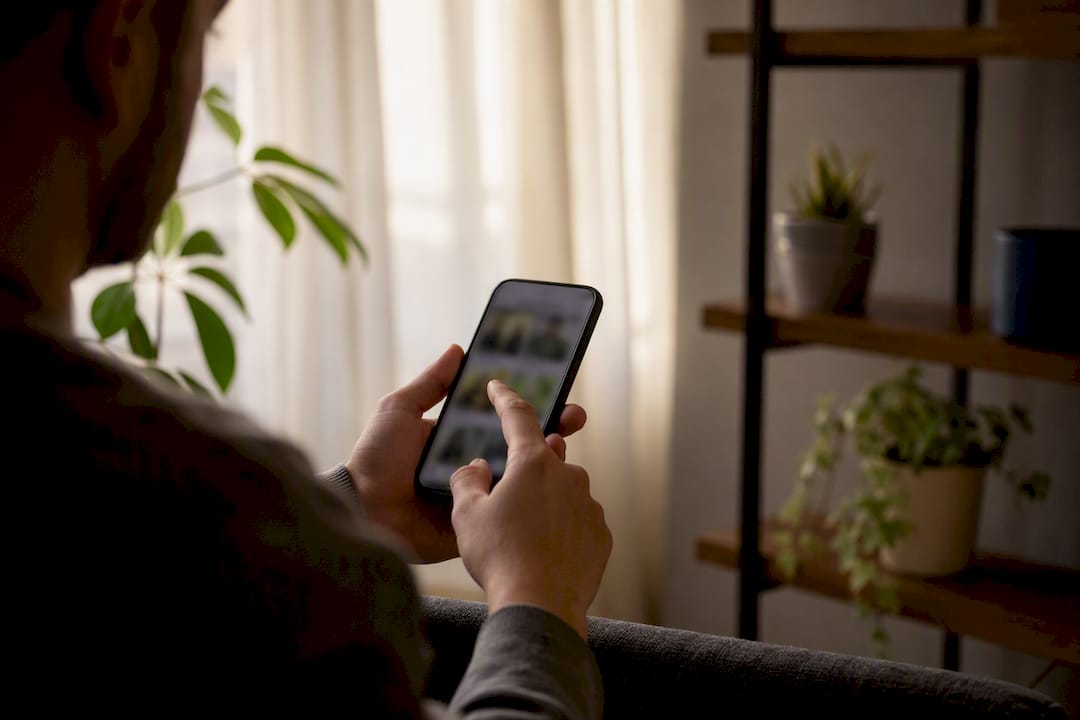 Hand holding smartphone previewing thumbnail