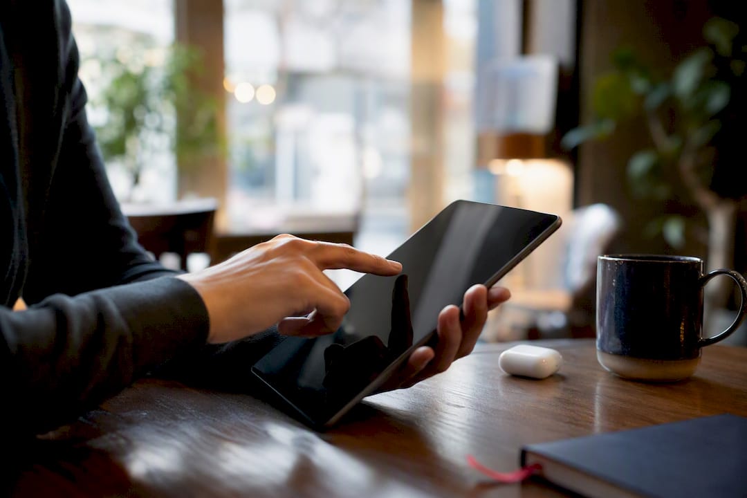Hands interacting with tablet for AI ad pre-testing