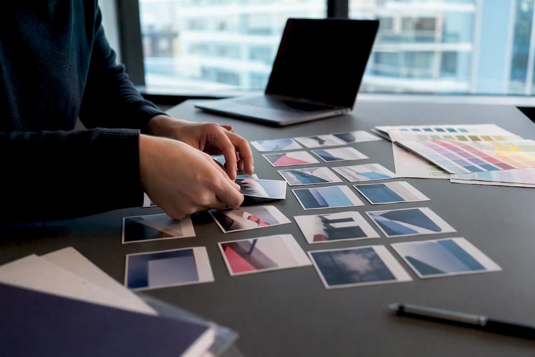 Hands arranging ad variant cards for test matrix