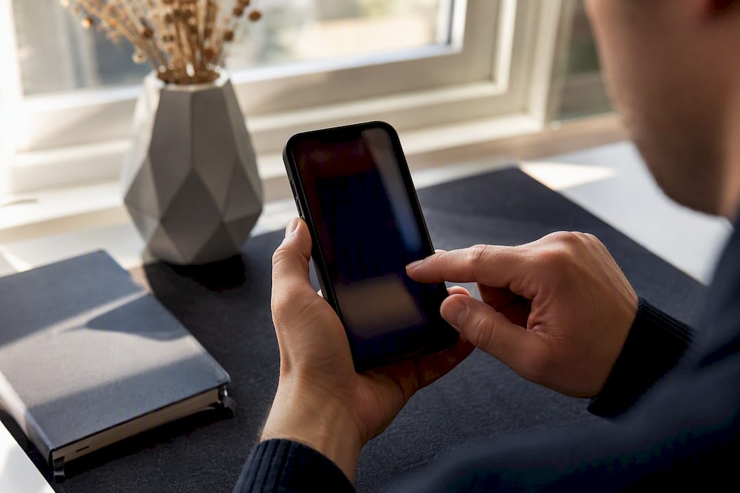 Hand using phone to score email lines