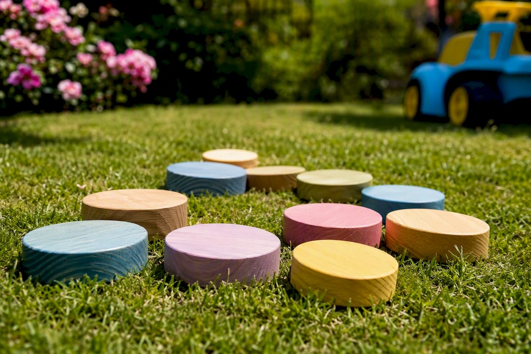 Painted wooden DIY stepping stones outdoors