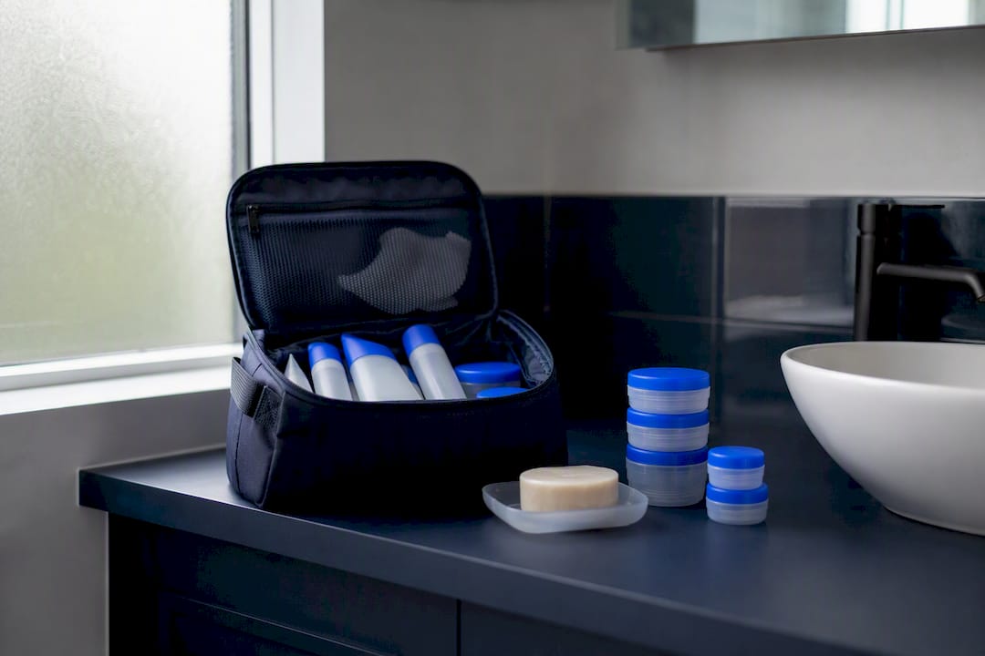 Downsized travel toiletry kit on countertop