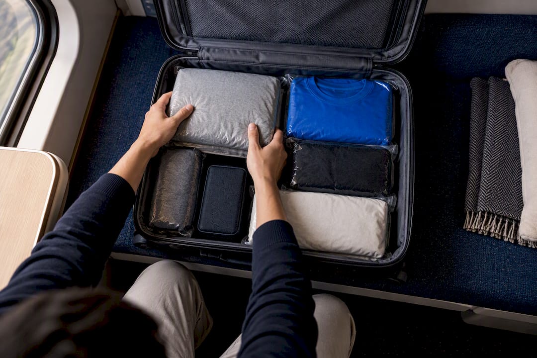 Compressed clothing blocks arranged in suitcase
