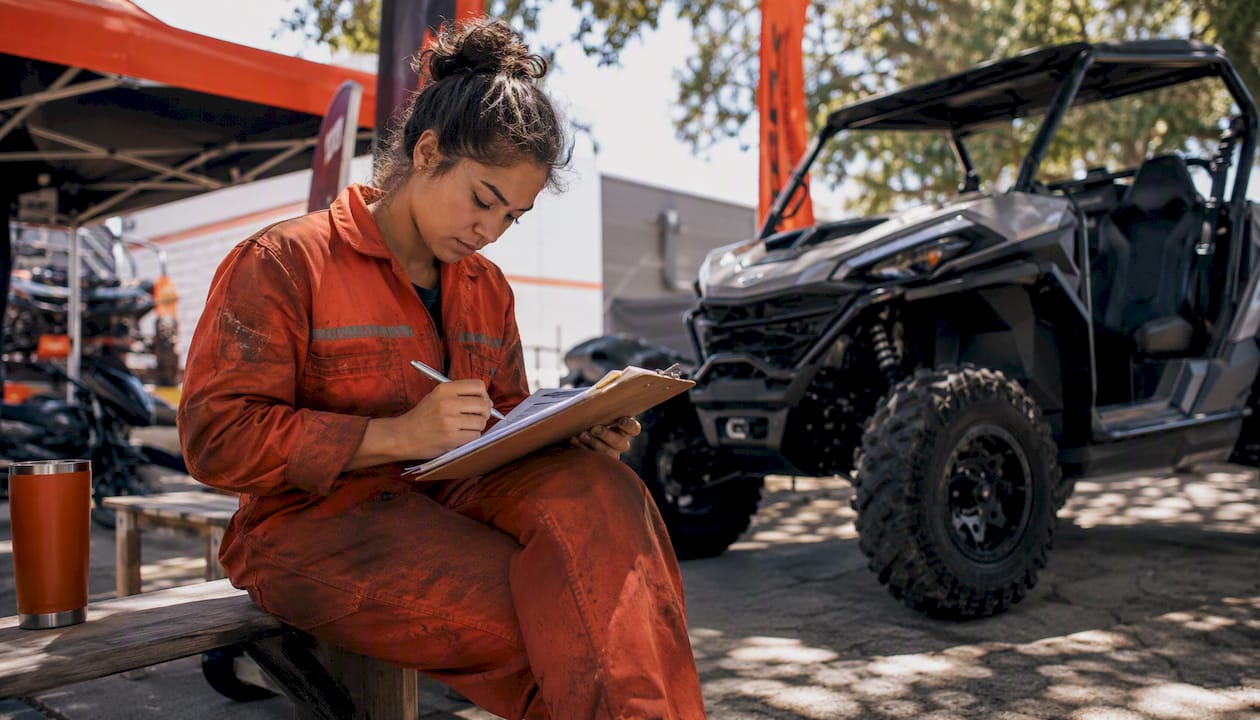 CFMOTO dealer mechanic reviewing warranty documents