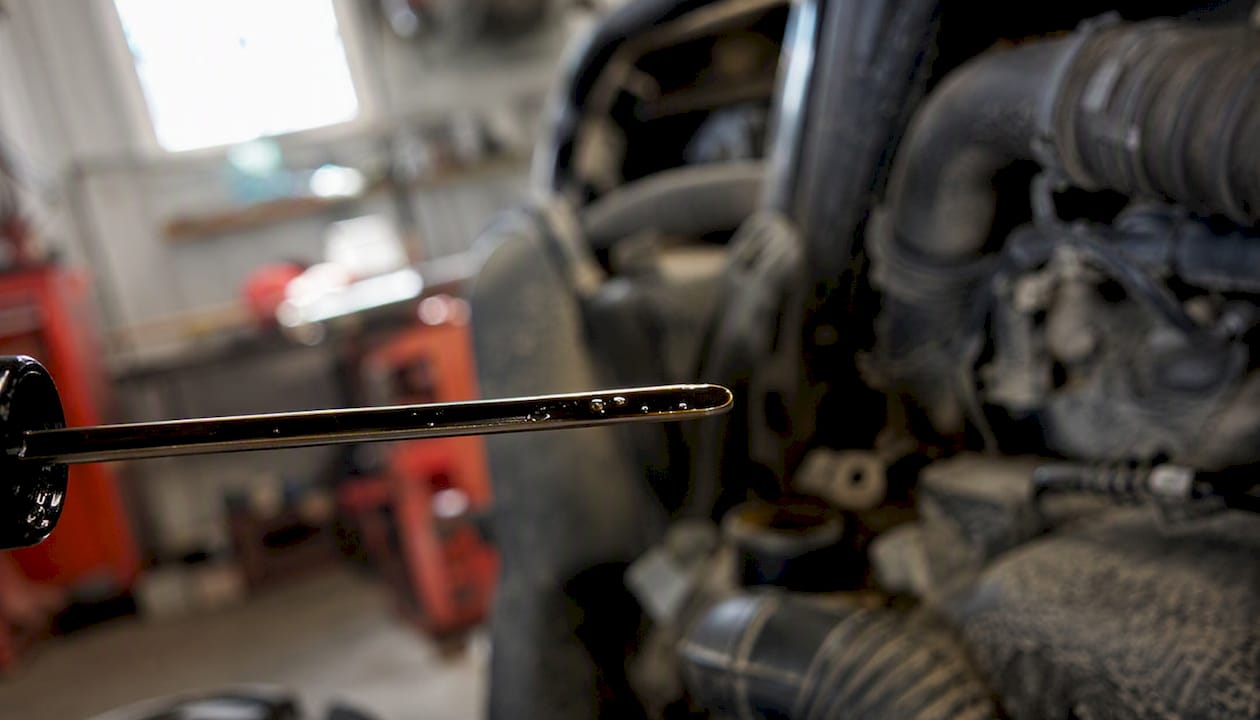 Close-up of used motorcycle oil on dipstick