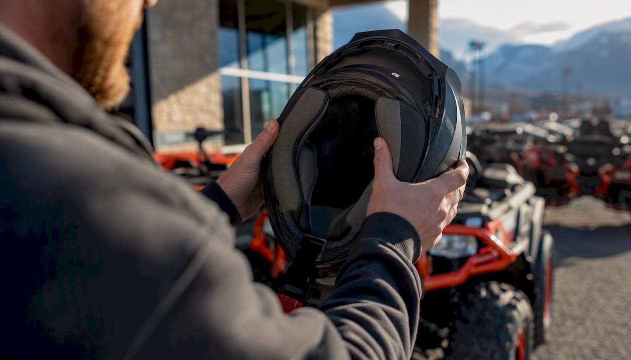Rider performing helmet roll-and-shake stability test