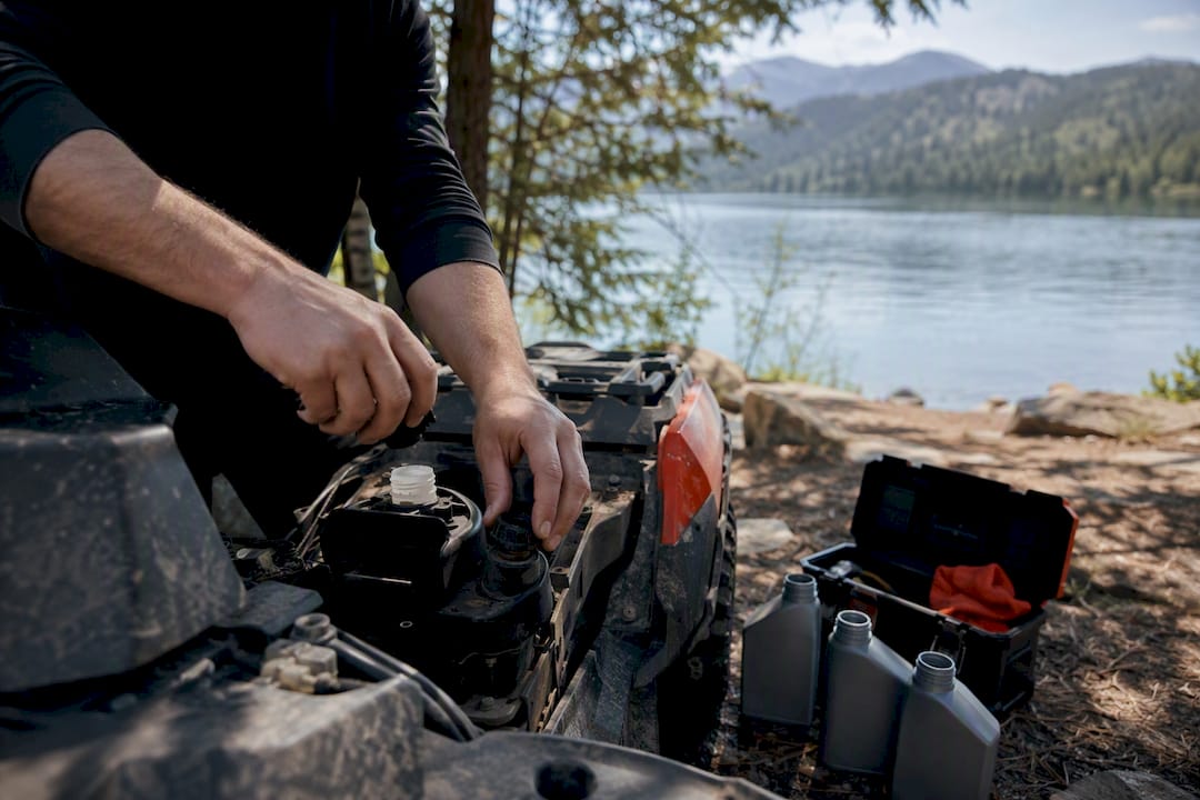 Rider checking engine fluids outdoors