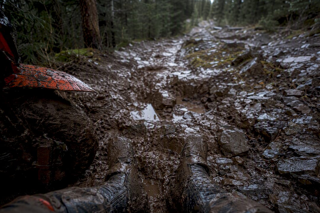 Muddy rugged ATV trail terrain