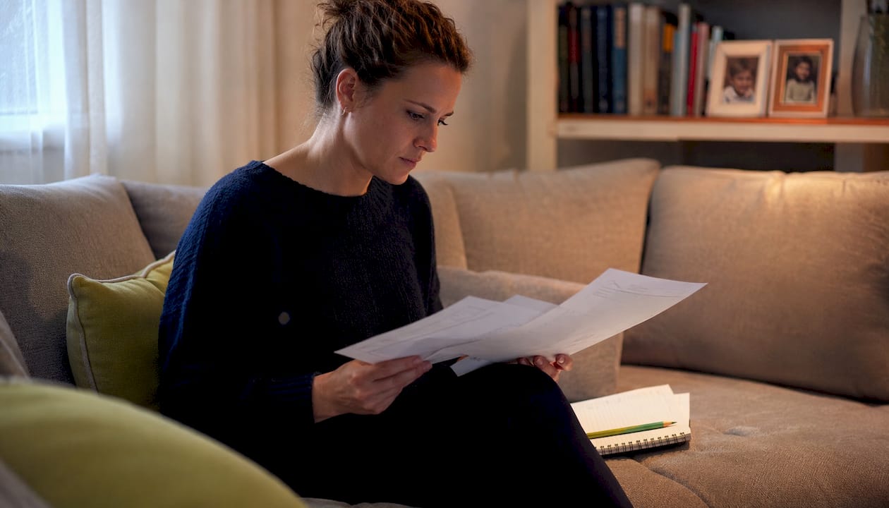 Woman reviewing rewiring quotes at home table