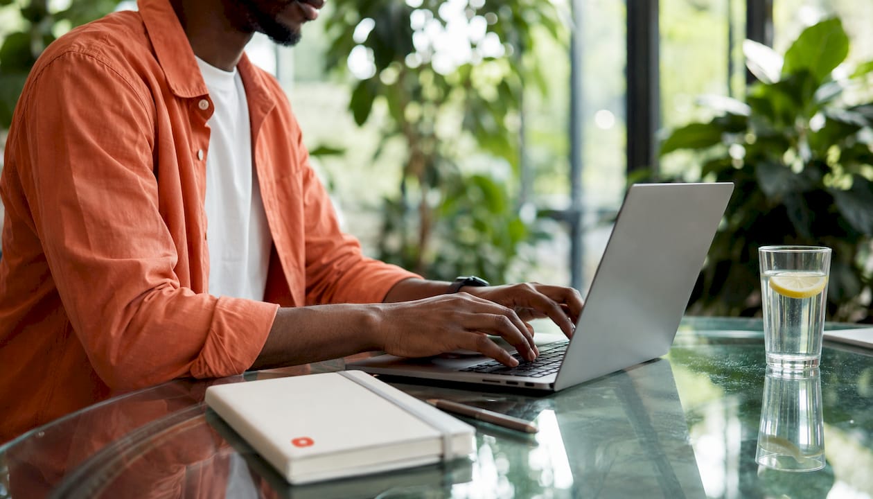 Close-up typing on laptop keyboard for file sharing