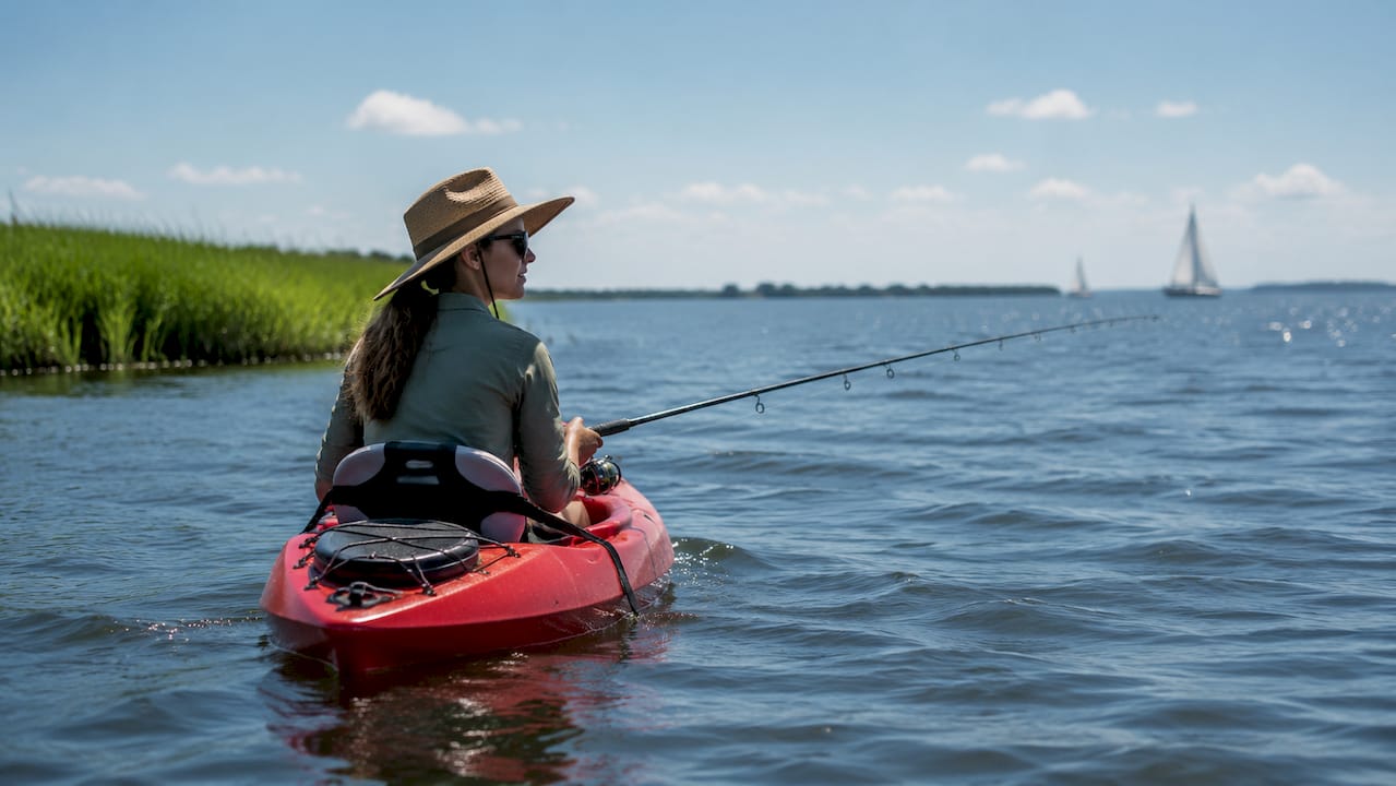 Woman kayak fishing for stripers on American River