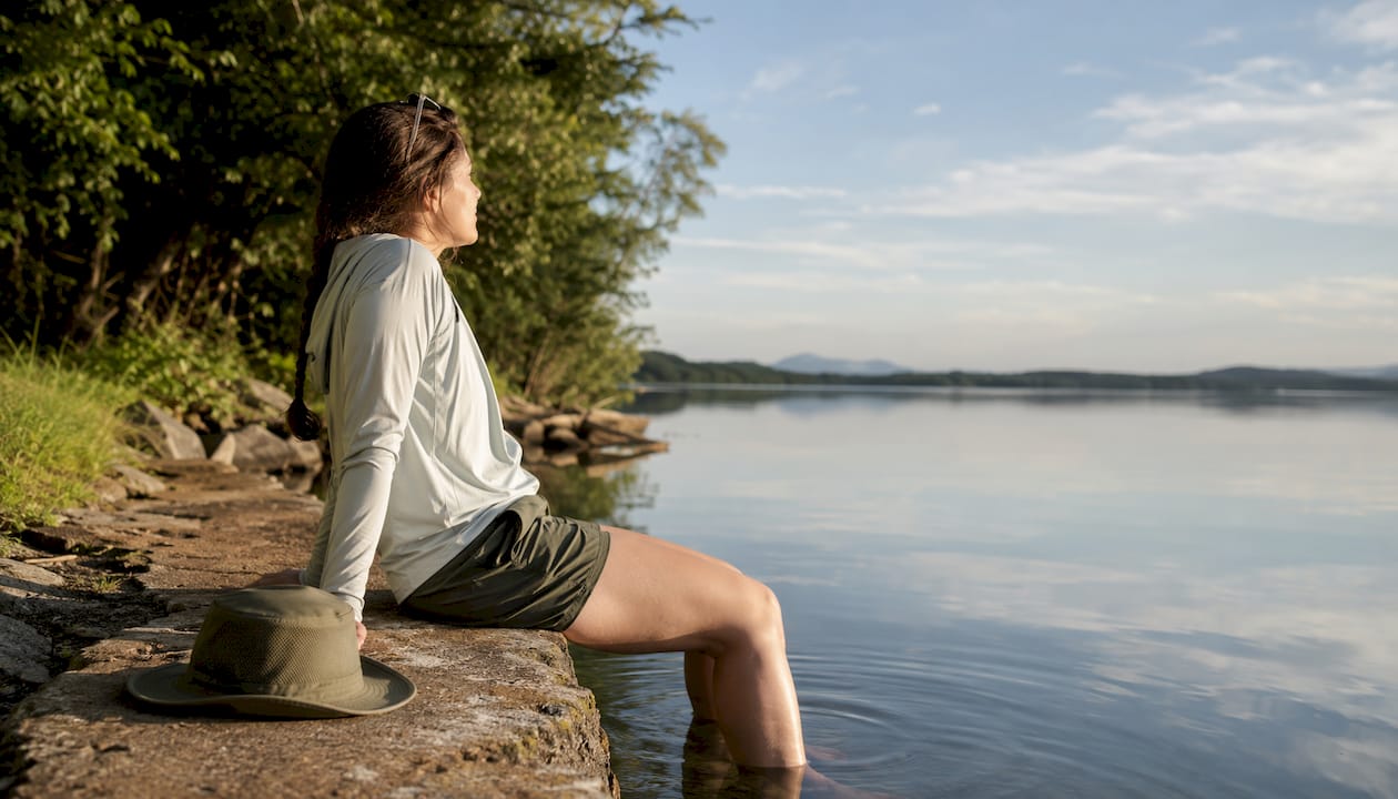 Woman on river dock in bamboo fishing shirt