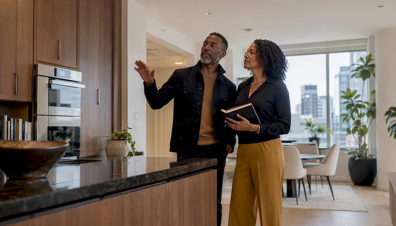Couple inspecting open kitchen layout