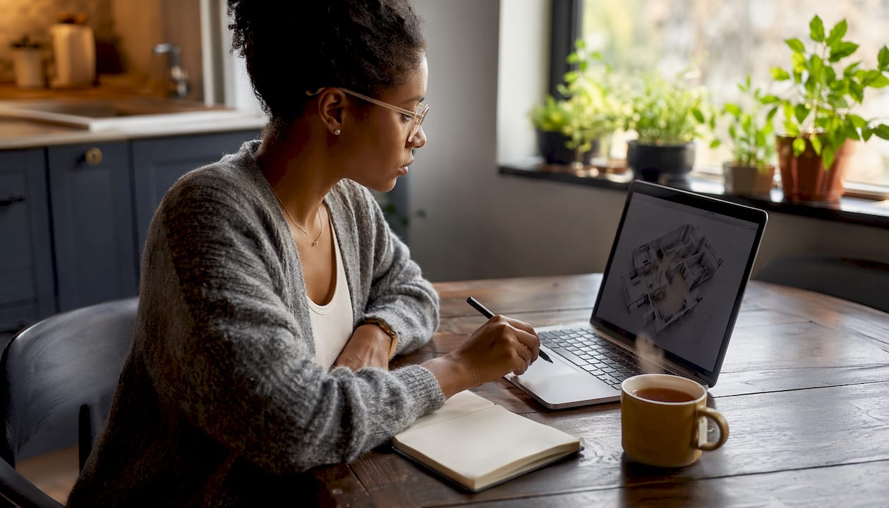 Woman using 3D floor plan software in office