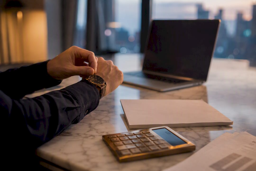 Workspace with calculator and documents for financing