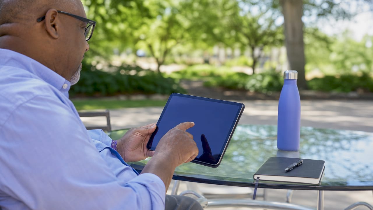 Hands interacting with tablet running on-device AI notetaker