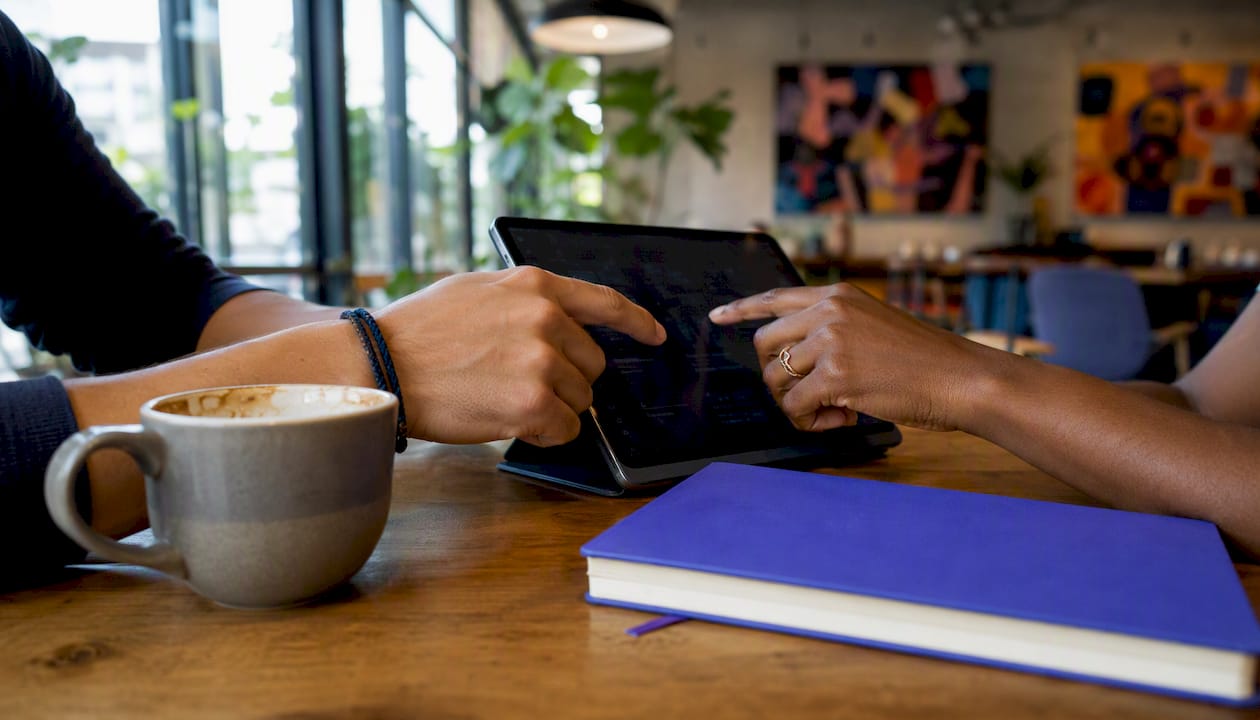 Close-up of hands evaluating SaaS tools on laptop