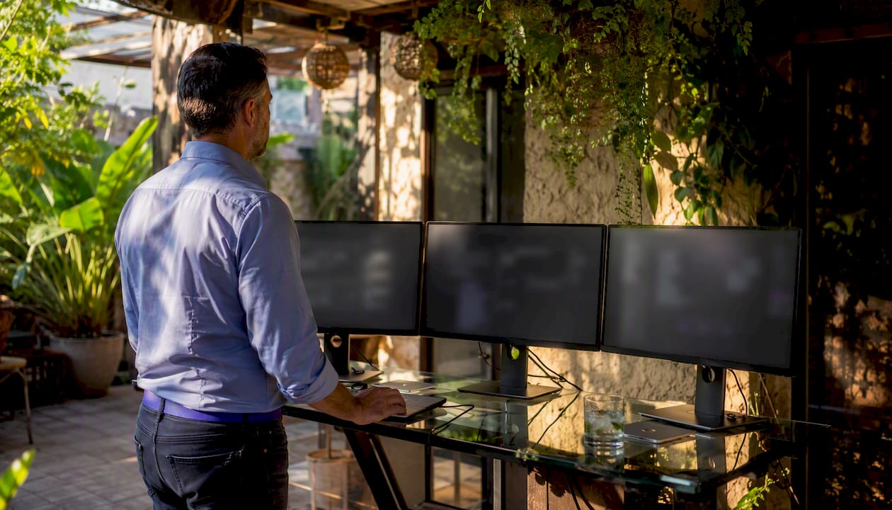 Sales engineer working at multi-monitor sandbox demo station