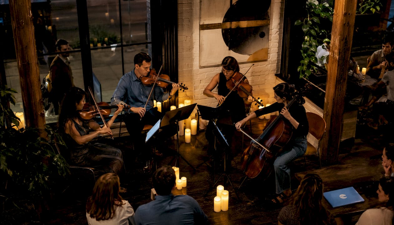 String quartet performing intimate candlelight concert in historic church