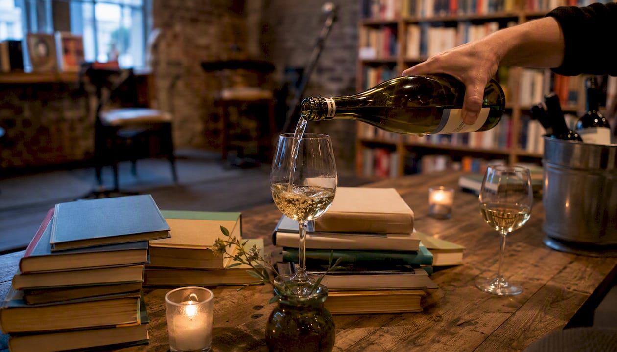 Wine pouring beside books at joint local event