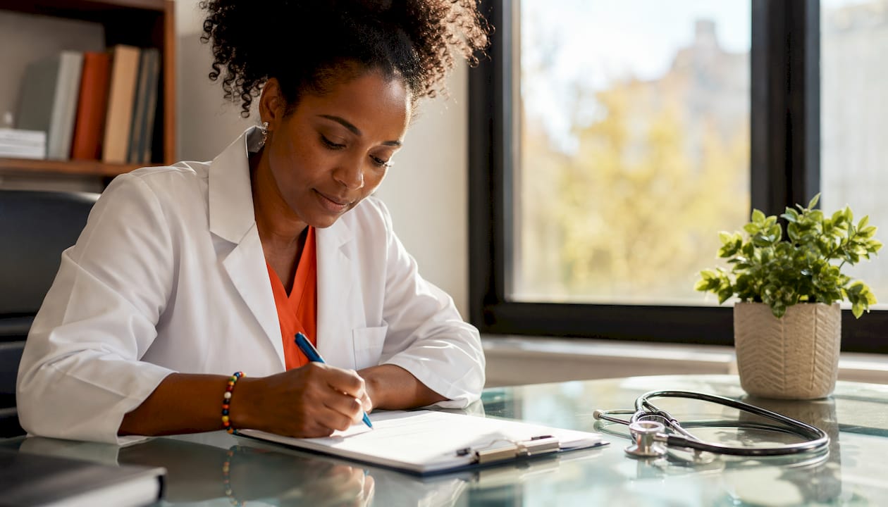 Doctor writing on Spain visa medical form