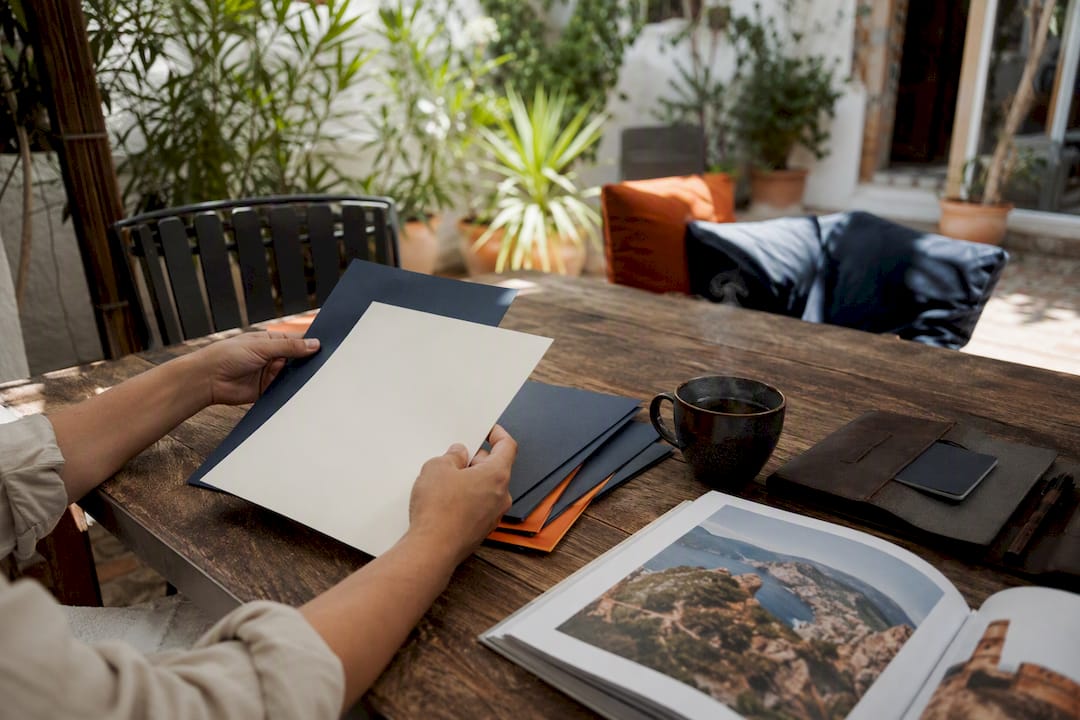 Hands organizing visa documents on table