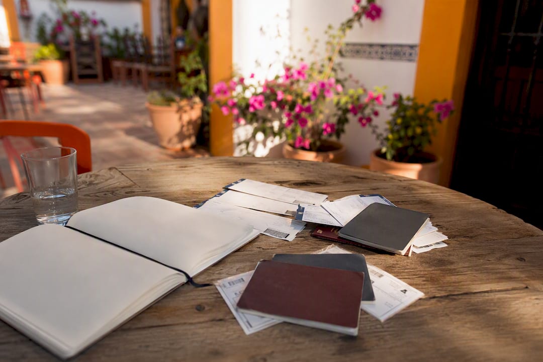 Travel documents and boarding passes on wooden table