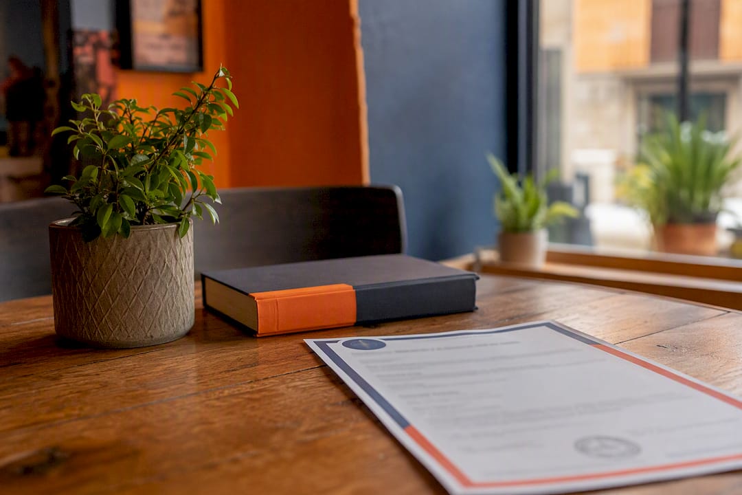 Visa insurance documents on table with Spanish flag pin