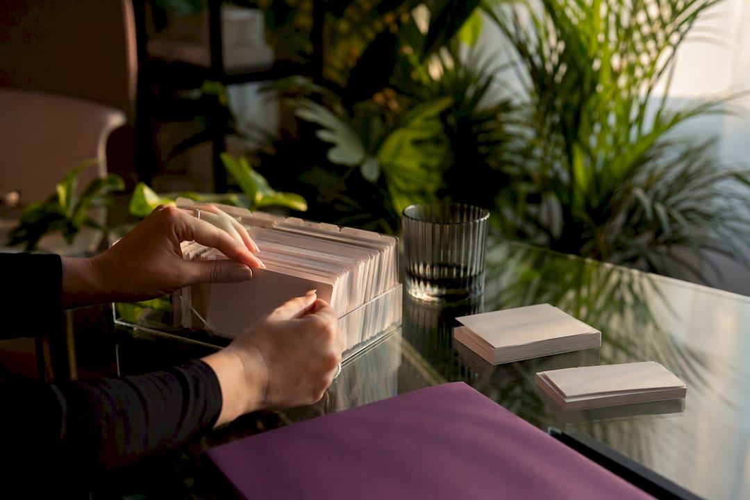 Hands placing appointment card in organizer
