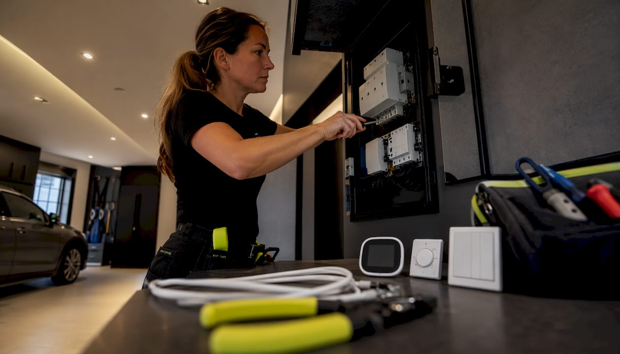 Electrician installing smart energy system panel