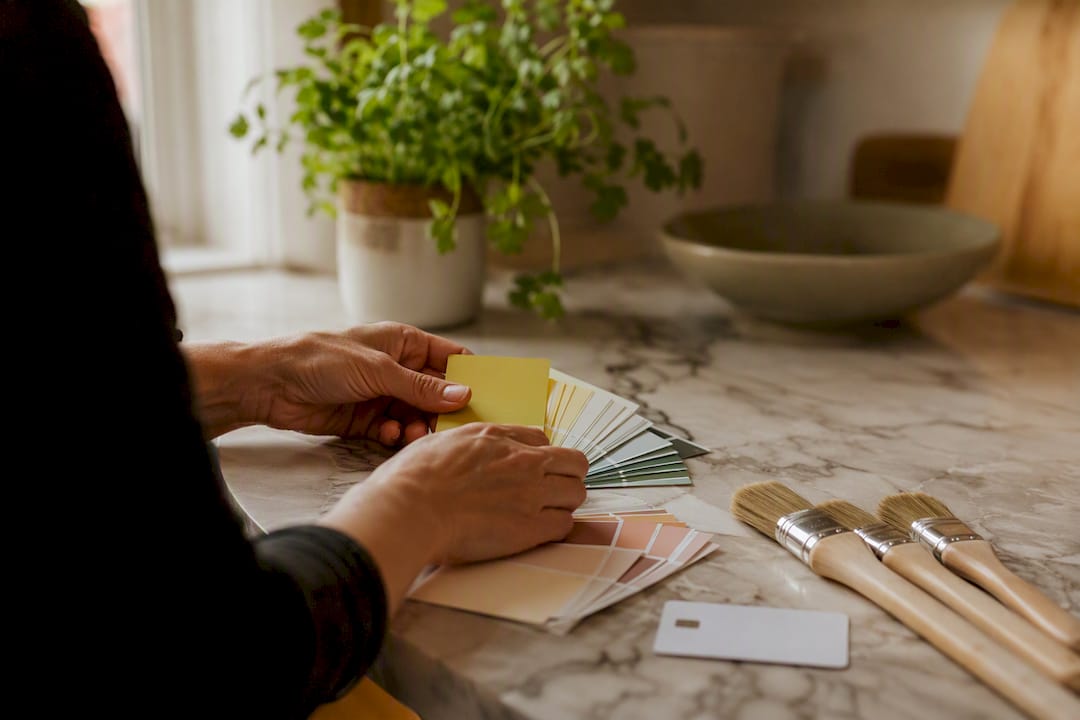 Hands with paint swatches and credit card
