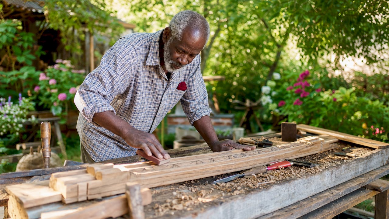 Close-up of craftsman sanding historic millwork