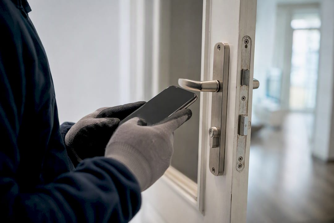 Hands photographing door hardware for inspection