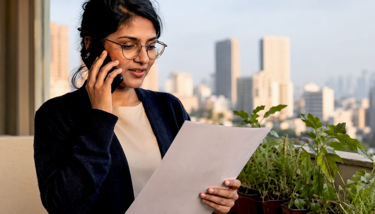Woman on phone holding PEFC certificate